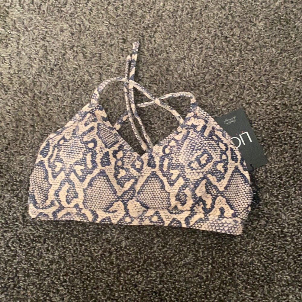 Brand New Lici fit sports bra tie in the back.